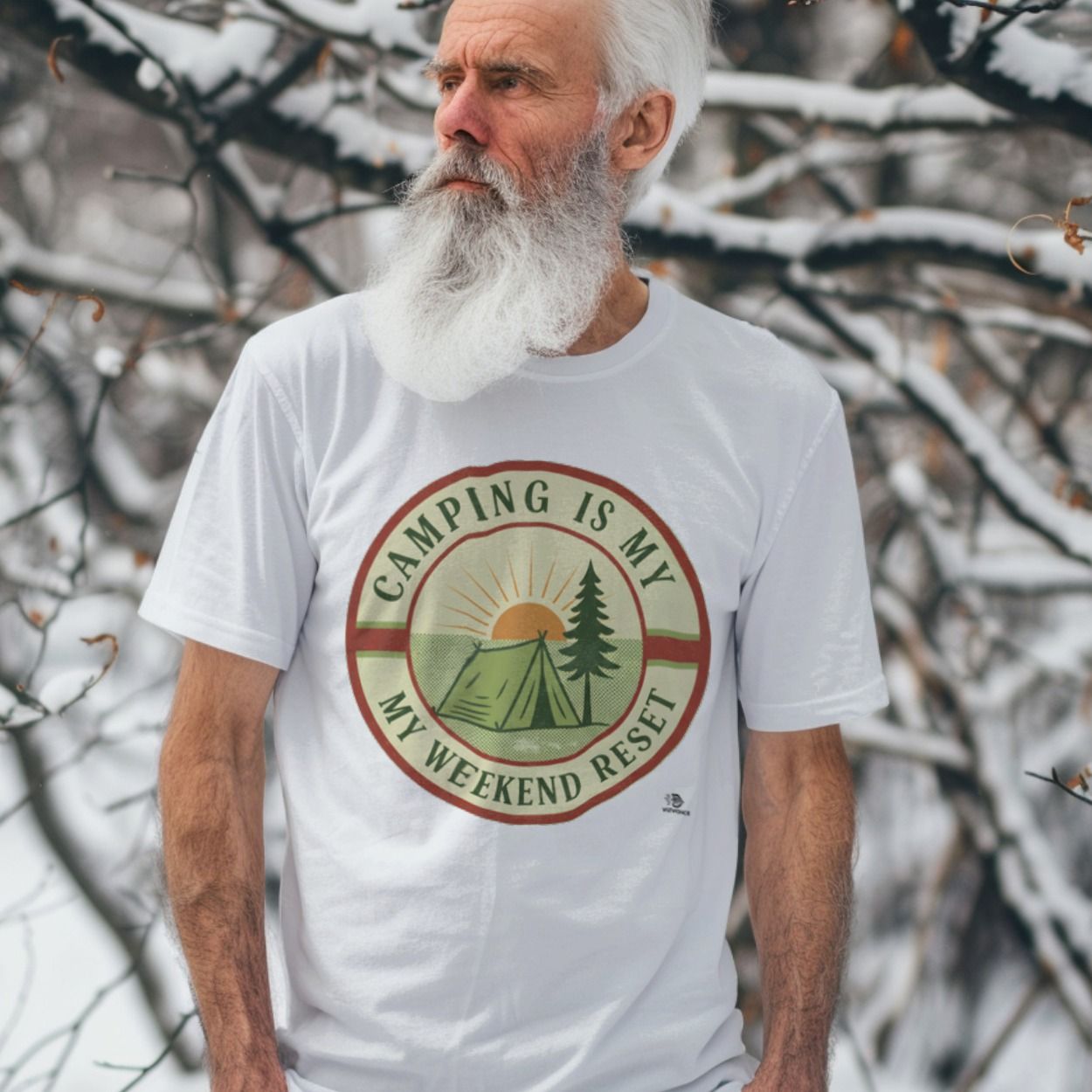 Bearded man in the snow wearing a camping tee